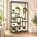 Aster six-tier black indoor plant stand styled with potted and hanging plants in a warm living room