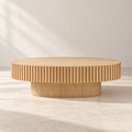 Forma oval coffee table with fluted apron and natural ash finish
