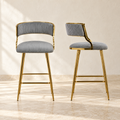 Two Linden gray corduroy counter stools with gold-tone legs and footrests