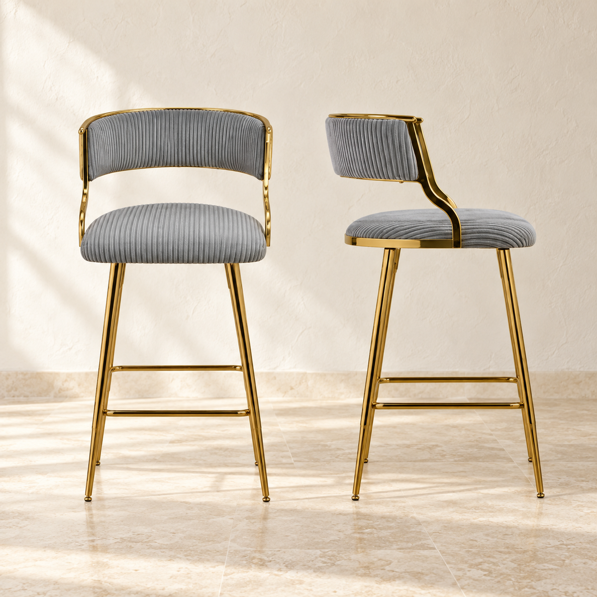 Two Linden gray corduroy counter stools with gold-tone legs and footrests