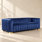 Belmont navy velvet sofa with vertical channels and gold-tone feet