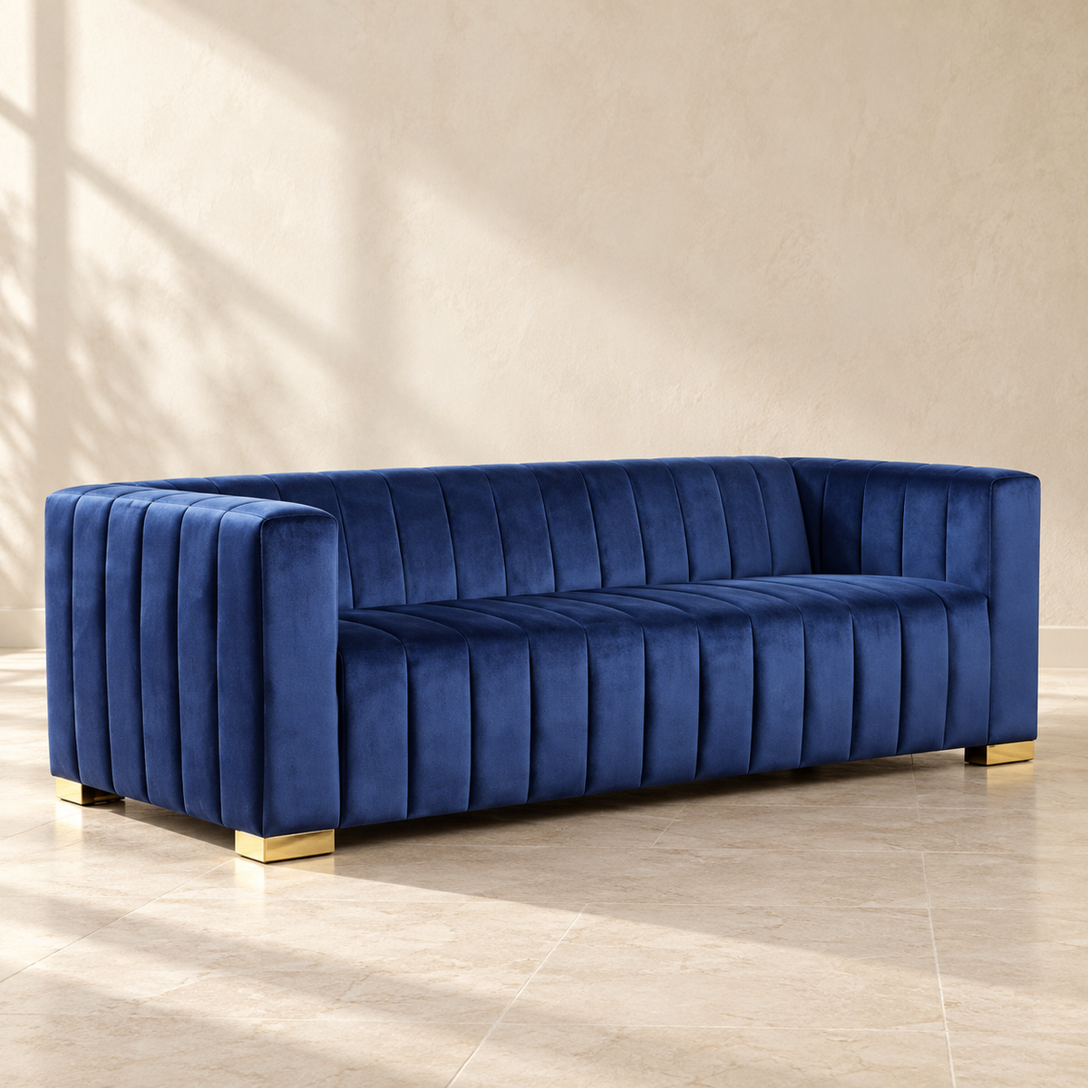 Belmont navy velvet sofa with vertical channels and gold-tone feet