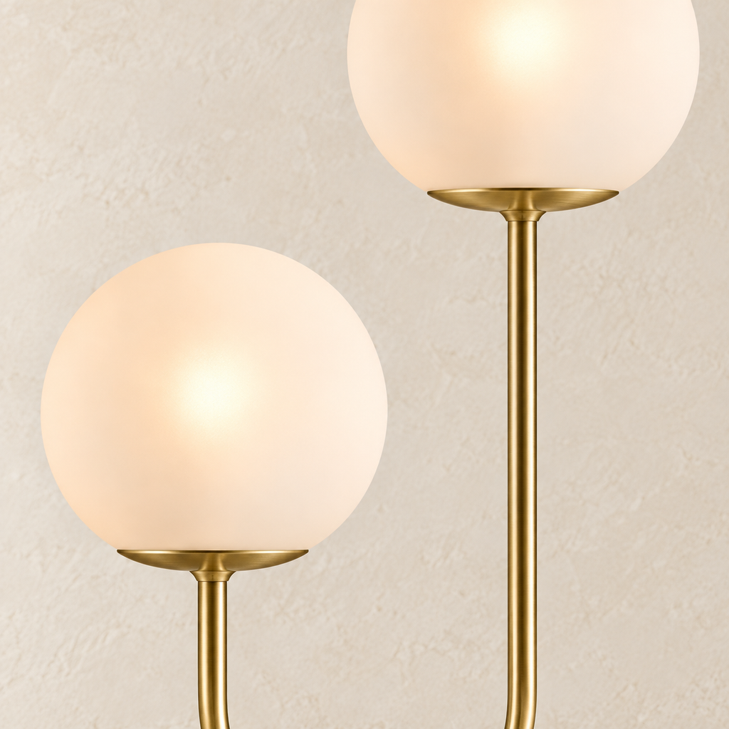 Close-up of Orbe’s glowing frosted globes and brass-tone stems