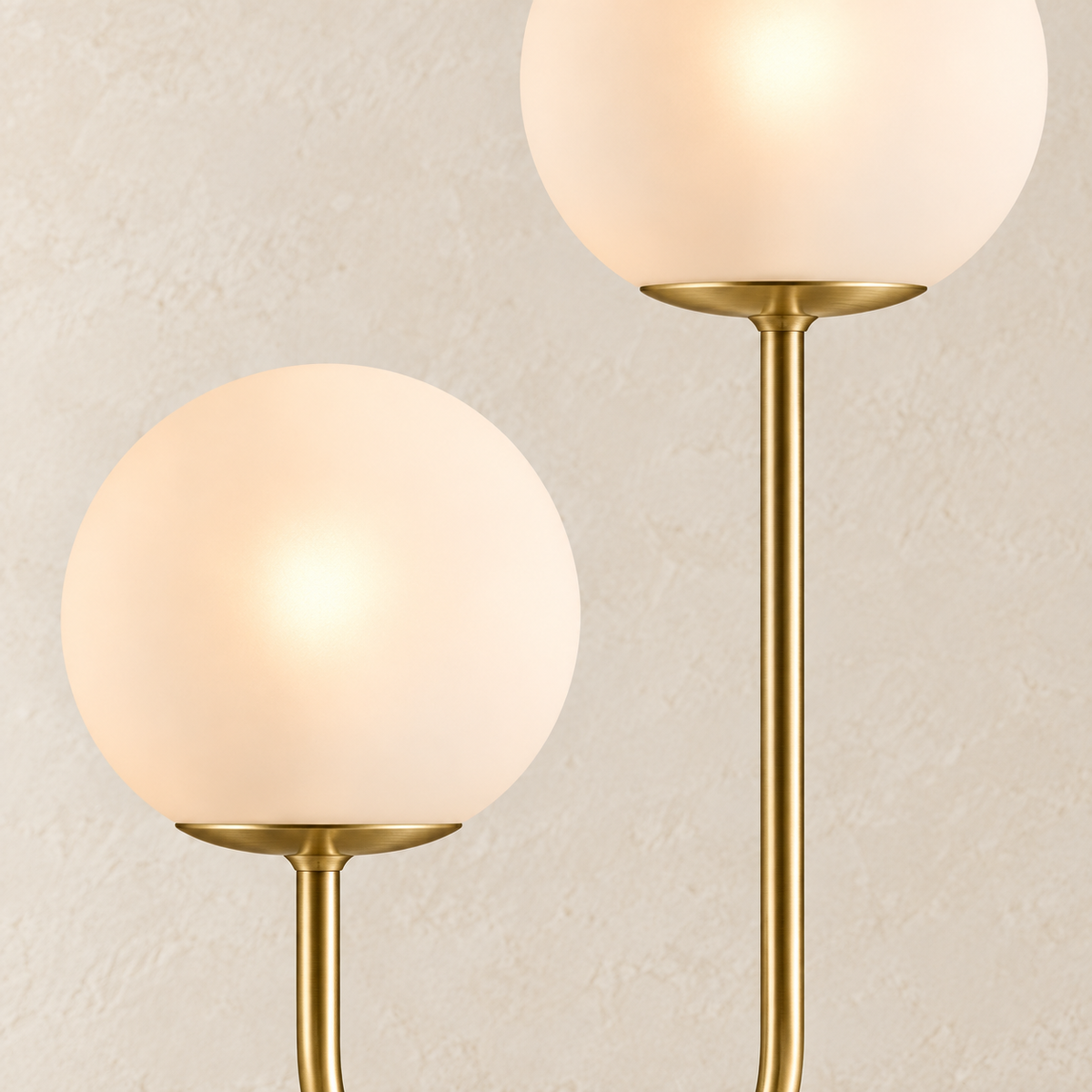 Close-up of Orbe’s glowing frosted globes and brass-tone stems