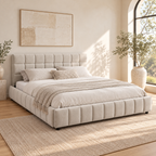 Beige chenille upholstered queen bed with a padded headboard and low frame in a softly lit bedroom.