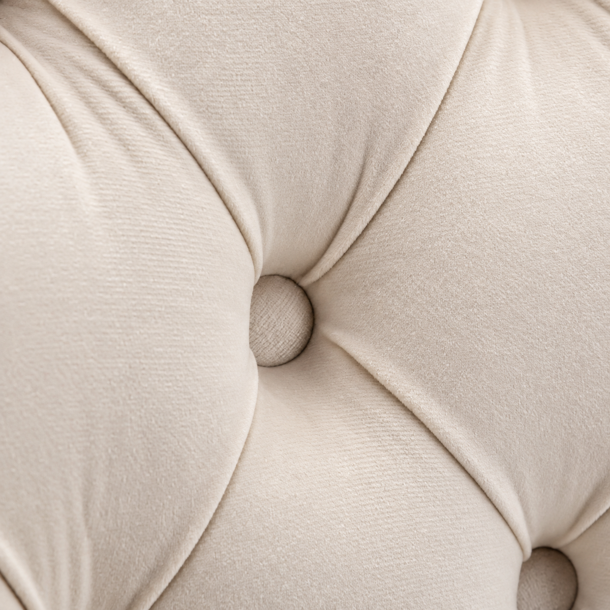 Close-up of Elara beige velvet button tufting