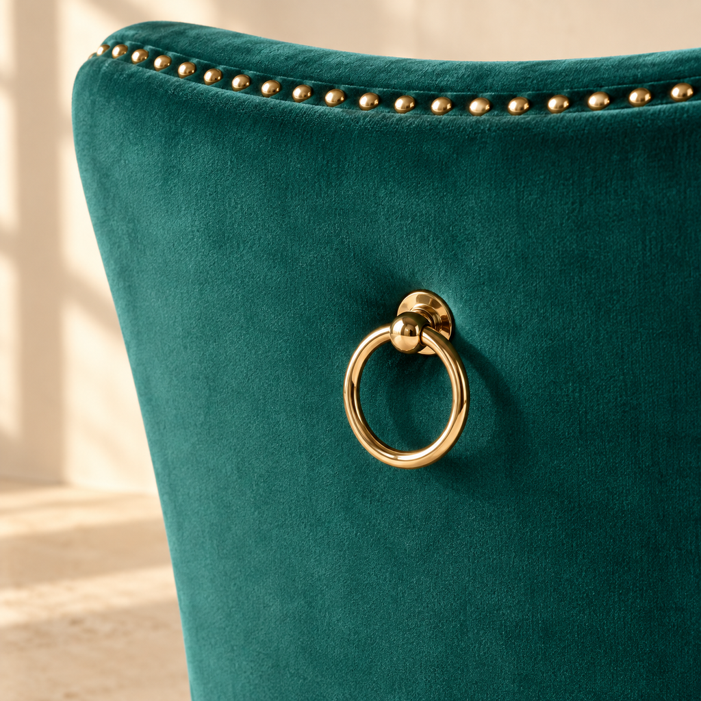 Gold ring pull on the green velvet back of an Elara dining chair