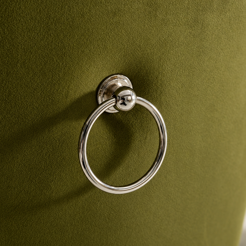Polished chrome ring pull on the olive velvet back of an Elara dining chair