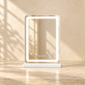 Lumi LED tabletop vanity mirror in the 13 x 17 size, styled on pale travertine