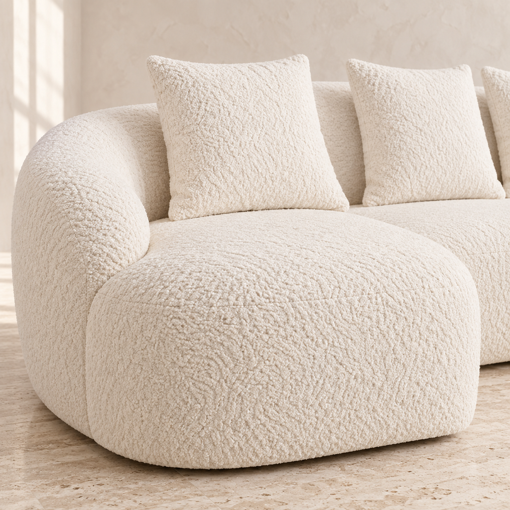 Close-up of Milo white chenille upholstery, rounded arm and matching pillows