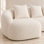 Close-up of Milo white chenille upholstery, rounded arm and matching pillows