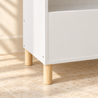 Close-up of natural pine legs and the Mira bookcase’s white cabinet finish