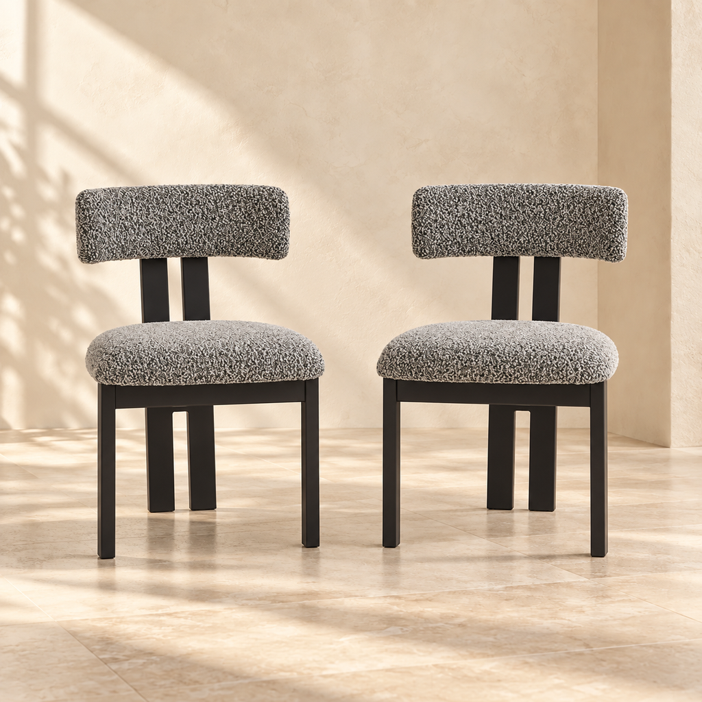 Two Nola black-and-white upholstered dining chairs in a warm cream interior