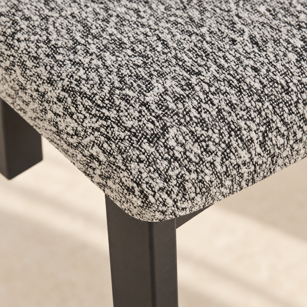 Close-up of the Nola chair’s textured black-and-white upholstery