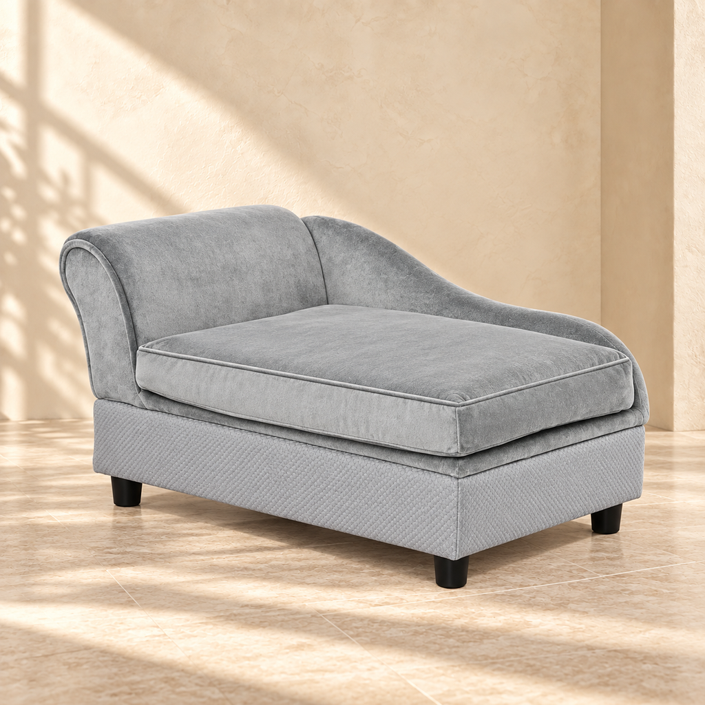 Pip gray pet sofa with curved back and cushioned seat on pale travertine