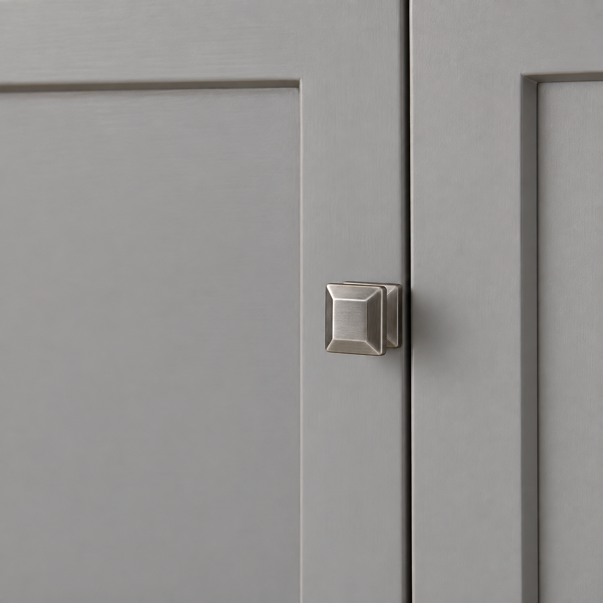 Close-up of the Wren gray painted shaker door and square silver knob