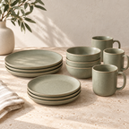 Stacked Sage plates and bowls with matching green mugs